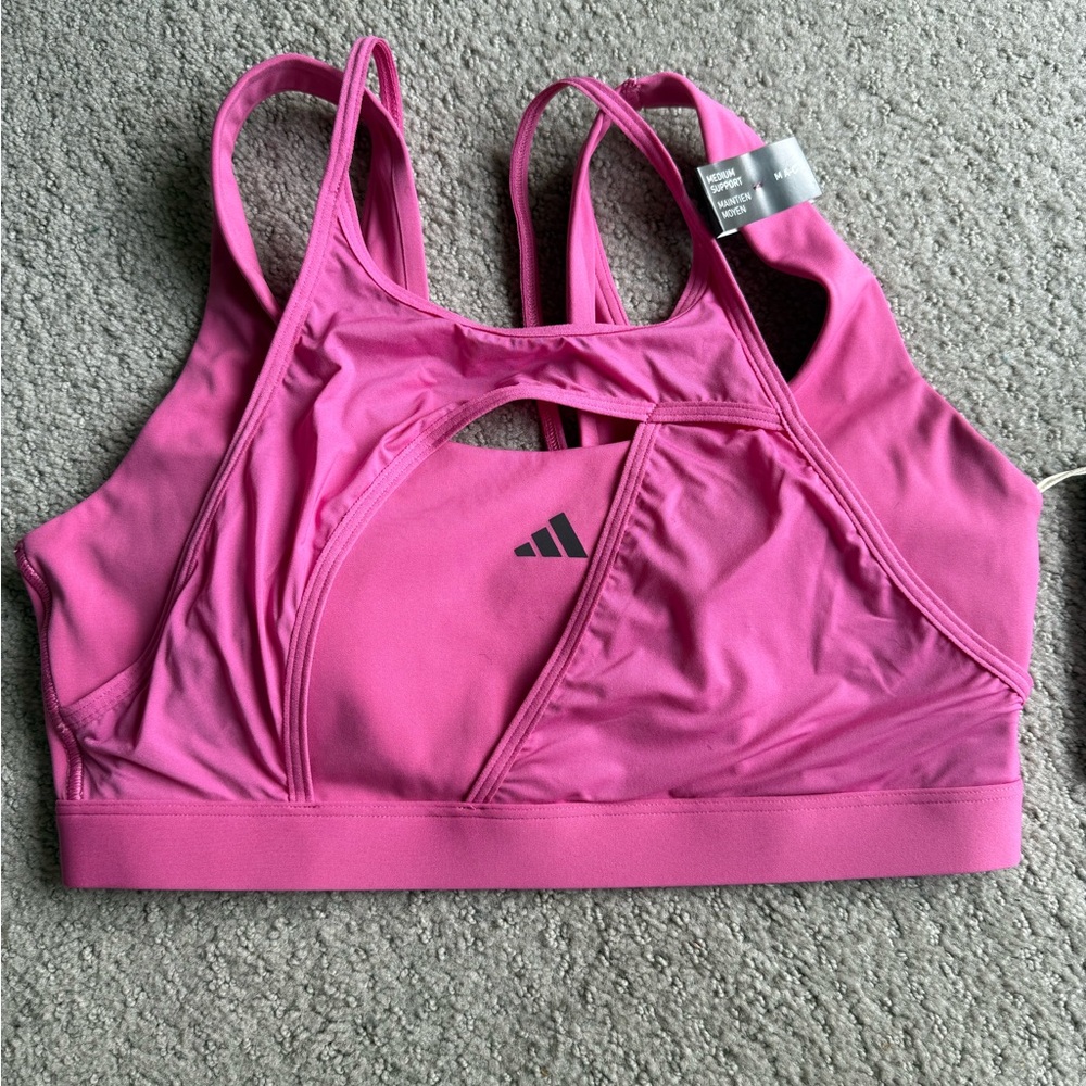 Adidas Pink Sports Bra with Racerback Design and adjustable straps for support.